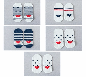Detailed view of assorted cotton ankle socks with cute stripes, dots and red heart heel patches