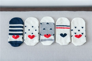 Flat lay of five pairs of cotton invisible socks with heart and stripe patterns