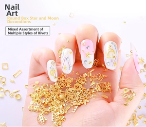 Macro view of gold metal nail art studs featuring moon and star alloy designs