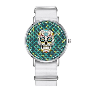 Detailed macro view of white nylon watch strap with colorful sugar skull dial design