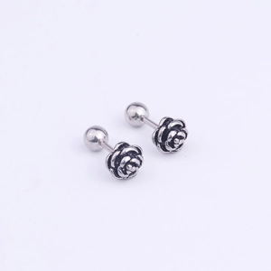 Detailed view of silver rose stud earrings with antique finish and ball back closures