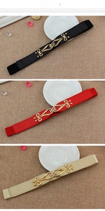 Detailed view of three thin elastic belts with gold zinc alloy buckles in black, red and beige