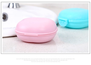 Close-up of pink macaron-style portable soap box with lid for travel convenience