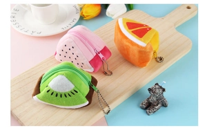 Cute fruit plush coin purses in dragon fruit kiwi and orange shapes on wooden board