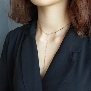 Detail of 925 sterling silver gold fringe Y-necklace on model in black suit