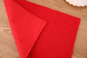 Detail of red Christmas placemat showing knit texture and soft velvet reverse side