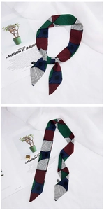 Silk scarf with geometric patterns tied on a book for a stylish lifestyle detail