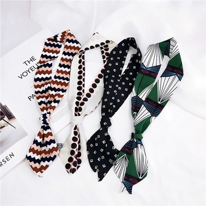 Narrow silk scarves set featuring wave patterns and geometric dots on soft fabric