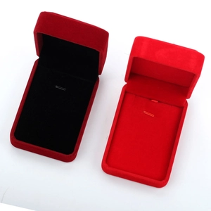 Macro detail of elegant red velvet jewelry boxes with inner hooks for necklaces