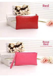 Detail of red and rose red clutches with crocodile texture and sturdy zippers