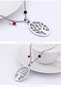 Close-up of silver Tree of Life necklace with crystal inlay and colored beads decoration