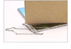 Detail of high-quality gold evening bag featuring dense rhinestones and metal chain