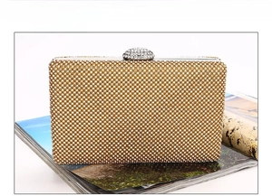 Detailed view of handmade luxury evening clutch bag with dense golden rhinestones
