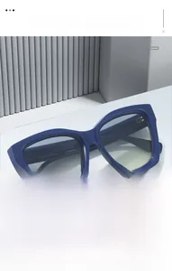 Detailed macro view of dark blue Y2K cat-eye sunglasses with gradient transparent lenses