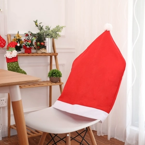 Detail of red Santa hat chair cover with white pom-pom on a modern chair