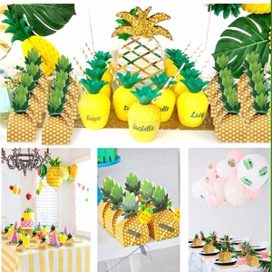 Detail of pineapple party favor boxes and customized cups for tropical themed decorations
