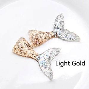 Detail of DIY mermaid tail accessories with gradient champagne gold sequins and resin