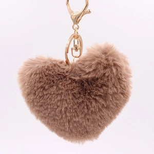Detailed view of the soft brown faux fur heart keychain with a golden metal clasp