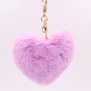Close-up of pink heart-shaped plush keychain with a gold metal clasp on light background