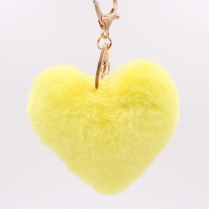 Close-up of a soft yellow heart plush keychain with a gold metallic hook and chain