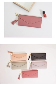 Detail of long envelope wallet with heart pendant, tassel accent and multiple color options
