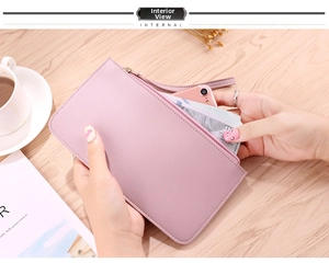 Detail view of pink long wallet interior showing large capacity for smartphone and cash