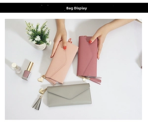 Detailed view of long envelope wallets featuring elegant heart pendants and leather tassels