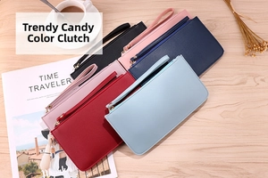 Lifestyle shot of multi-color long wallets with wrist straps on a cozy table setup