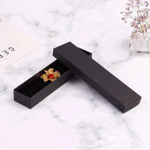 Matte black rectangular kraft paper jewelry gift box with a textured lid on marble background