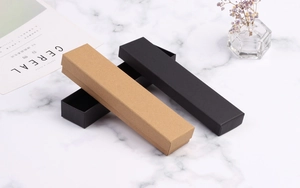 Rectangle kraft and matte black jewelry gift boxes shown in an aesthetic setup