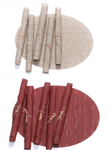 Detail of oval woven PVC placemats in beige and red, showing rolled storage and heat resistance