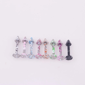Detailed view of 8 colorful splatter painted stainless steel labret studs with cone tips