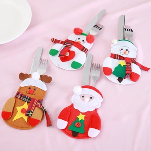 Detail of Christmas snowman, reindeer and Santa cutlery holders on pink background