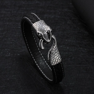 Mens woven leather bracelet featuring detailed stainless steel snake head and tail buckle