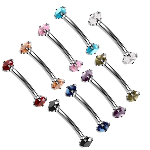 Close-up of curved eyebrow barbells with colorful cubic zirconia in four-claw settings