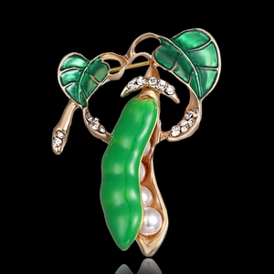 Detail of pea pod brooch with green enamel, white pearls and sparkling crystals