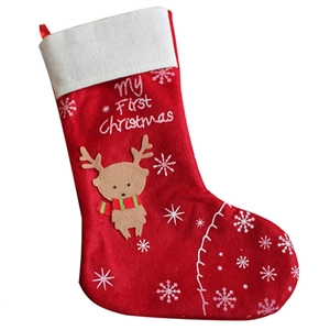 Red felt Christmas stocking with reindeer embroidery and My First Christmas text