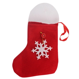Detail of red felt Christmas stocking with large white snowflake and hanging loop