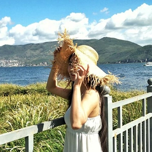 Outdoor straw sun hat with wide frayed brim and natural weave for beach trips
