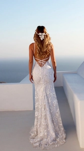 Detail of white floral lace evening dress with open back and criss-cross straps