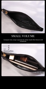 Detail view of large capacity black crocodile leather clutch bag with top zipper closure