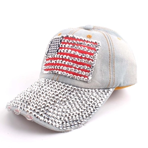 Close-up of denim baseball cap with rhinestone American flag and distressed brim details