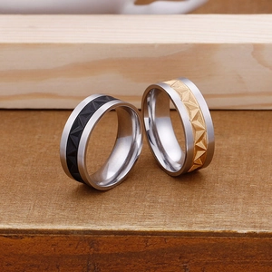 Men's titanium steel rings with textured geometric embossing in black and gold finishes