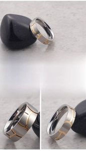 Macro detail of silver titanium steel ring with brushed finish and gold wavy groove pattern