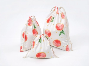 Detail of printed cotton linen drawstring bags with grapefruit and yellow dot patterns