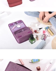 Detail view of purple multi-compartment travel toiletry bag with mesh pockets and elastic slots
