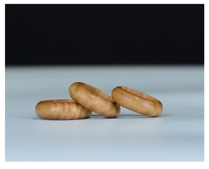 Detailed view of three natural green sandalwood rings with fine wood grain textures
