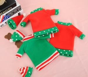 Detail of Christmas wine bottle cover with red and green knitted sweater and mini hat