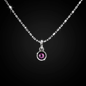 Close-up of a silver bead chain necklace featuring a brilliant pink rhinestone pendant