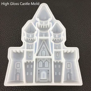 High-gloss castle silicone mold for resin DIY crafts on a dark textured background